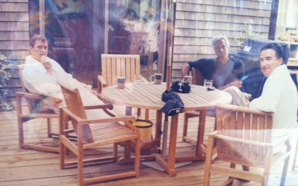 This undated photo in an unidentified location provided by the US Department of Justice on 13 March, 2026 shows, Andrew Mountbatten-Windsor and Lord Peter Mandelson wearing bathrobes seated alongside late financier and convicted sex offender Jeffrey Epstein. Photo: HANDOUT