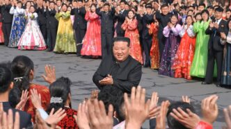 North Korean leader Kim Jong Un greets people during a visit to a coal mine run by young workers to cast his ballot in an election for the Supreme People's Assembly in North Korea, March 15, 2026.