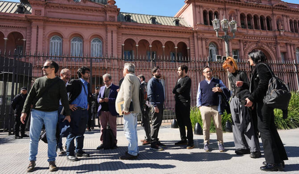 Journalists stand outside of the Casa Rosada government headquarters after President Javier Milei blocked their access, in Buenos Aires, Argentina, Thursday, April 23, 2026. 