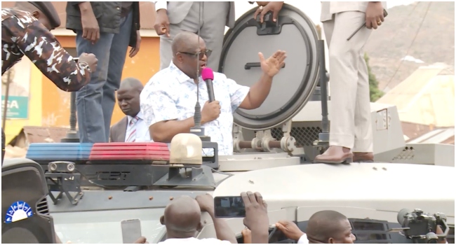 Governor Caleb Mutfwang,addressing a tense crowd from an armoured tank carrier (ATC) after the Palm Sunday attack in Jos