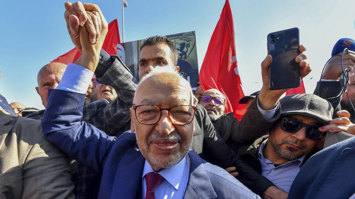 Ghannouchi greets supporters outside a police station after responding to a summons in February 2023, two months before his eventual arrest 