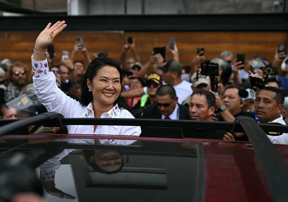 Keiko Fujimori waves as she leaves a polling station during the presidential election runoff in Lima on June 7