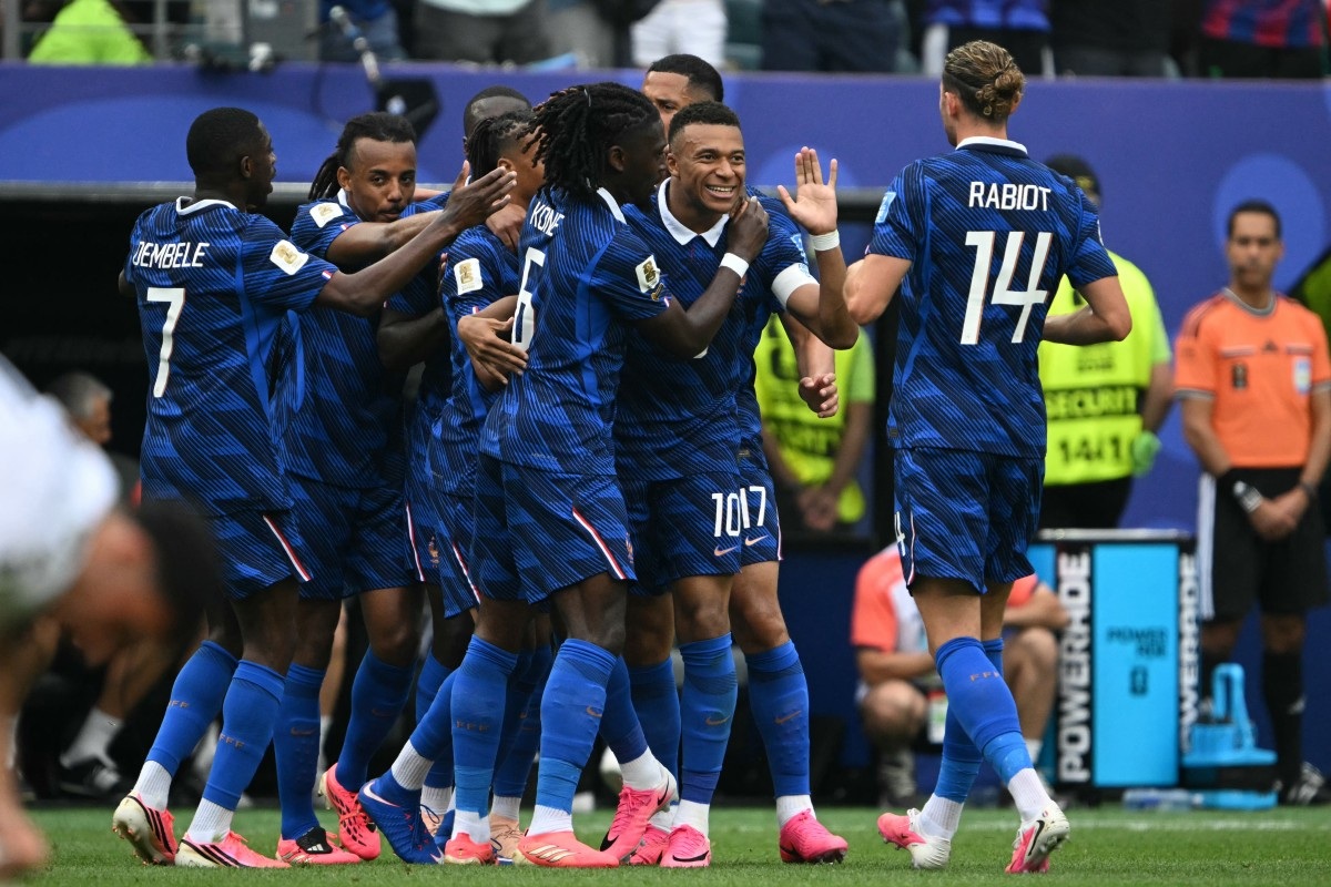France forward Kylian Mbappé celebrated his 100th international appearance in style on Monday, scoring twice as France secured a comfortable 3-0 victory over Iraq in a World Cup group-stage match that was interrupted for more than two hours by severe weather.