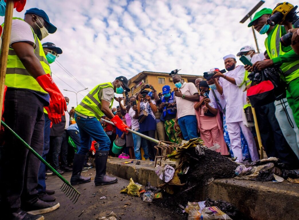 Sanwo-Olu clearing refuse during the monthly environmental sanitation exercise on Saturday.