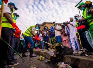 Sanwo-Olu clearing refuse during the monthly environmental sanitation exercise on Saturday.