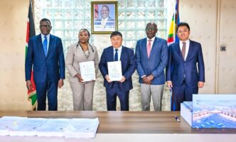 (From Left) Transport CS Davis Chirchir, Aviation and Aerospace Development PS Teresia Mbaika, CRBC General Manager Yu Xiaodong and other officials at the signing of the JKIA expansion deal on June 23, 2026. Credit: Citizen Digital.