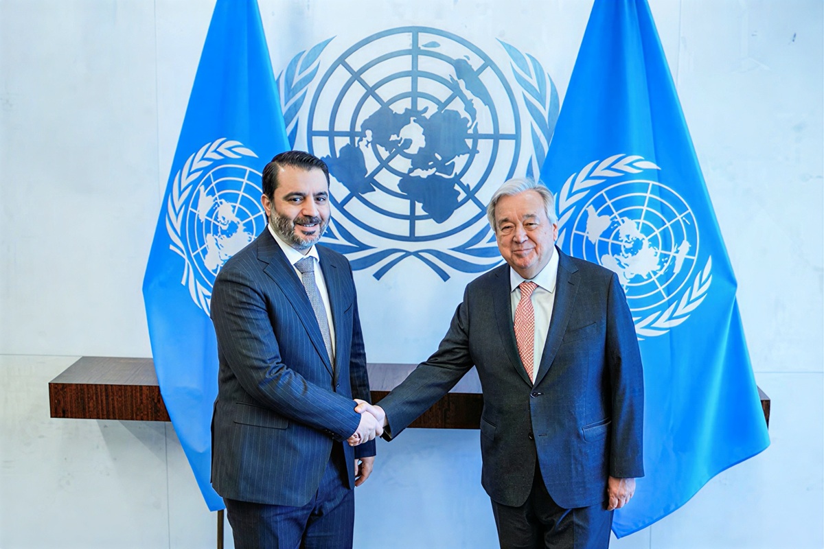 Syrian Foreign Minister Asaad Hassan al-Shaibani shakes hands with United Nations Secretary-General Antonio Guterres