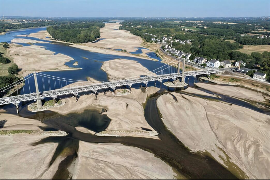 This aerial photograph shows a bridge over the dried out Loire River bed in Loireauxence (Varades), western France, on July 10, 2026