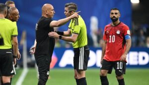 Egypt's head coach Hossam Hassan speaks with French referee Francois Letexier as Egypt's forward #10 Mohamed Salah looks on during the 2026 World Cup round of 16 football match between Argentina and Egypt at Atlanta Stadium in Atlanta on July 7, 2026. Credit: AFP.