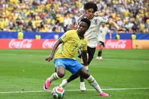 Brazil's Vinicius Jr (in yellow) in action against Japan's Ao Tanaka during their World Cup clash on June 29. Brazil won the match 2-1. PHOTO: REUTERS