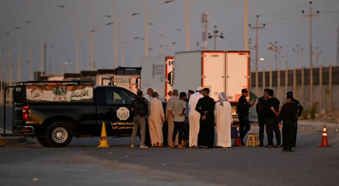 Stranded Iranians and Iraqis wait at the Iraq-Iran border following the Iraqi government's decision to close the Shalamsheh border crossing.