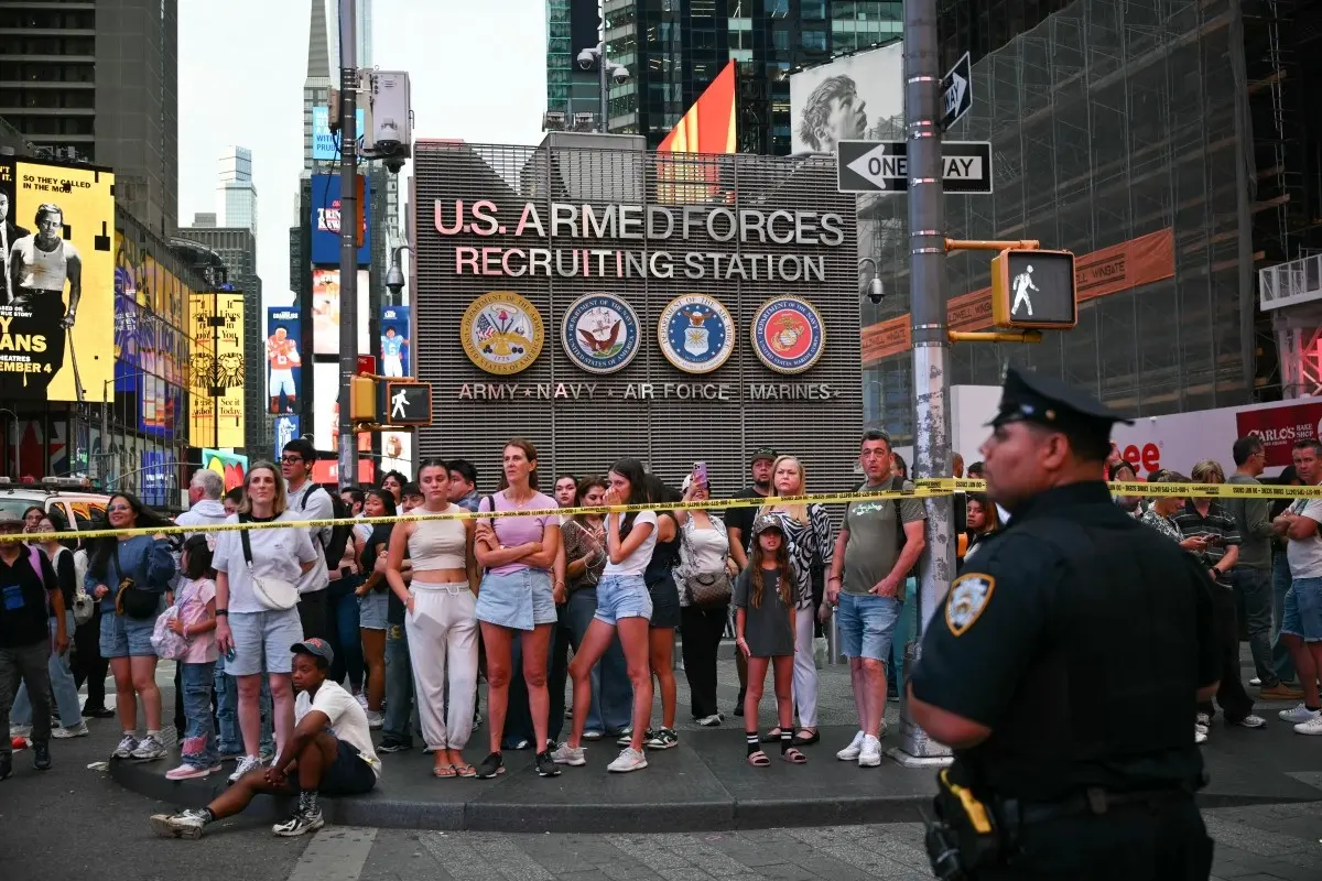 People observe the scene where an officer-involved shooting left one dead near Times Square, in New York, on August 31, 2026.