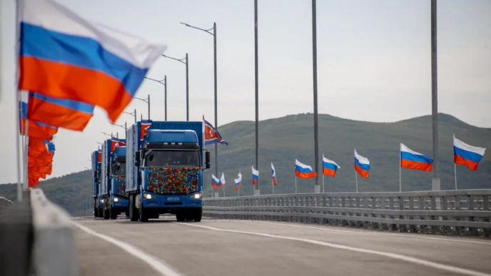 In this handout image released by the Russian Transport Ministry on September 7, 2026, national flags of Russia wave in the wind and North Korean trucks cross the new Russia-North Korea road bridge over the Tumen River, during the opening ceremony.