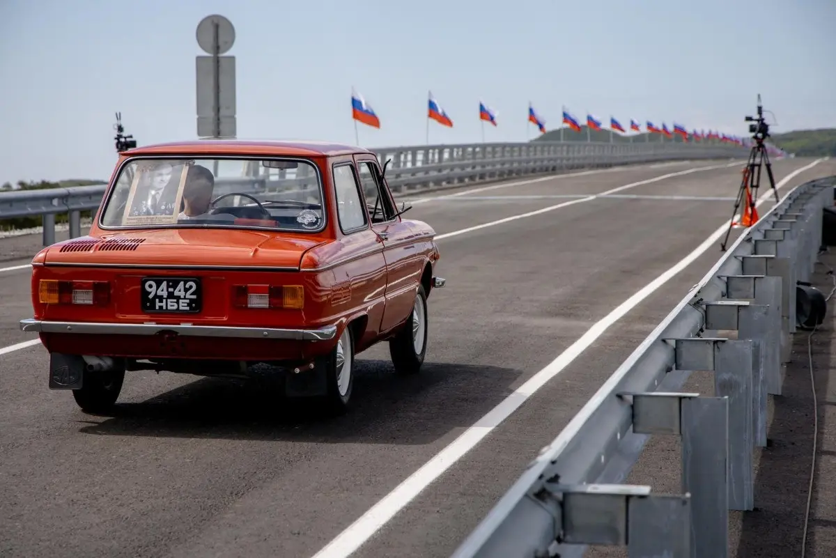 In this handout image released by the Russian Transport Ministry on September 7, 2026,a Zaporozhets car crosses the new Russia-North Korea road bridge over the Tumen River, during the opening ceremony.