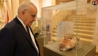 Lebanon's Minister of Culture Ghassan Salameh inspects illegally smuggled artifacts that date back to the Egyptian pharaonic era at the National Museum of Beirut on September 16, 2026, during a ceremony held to mark their handover back to Egypt.