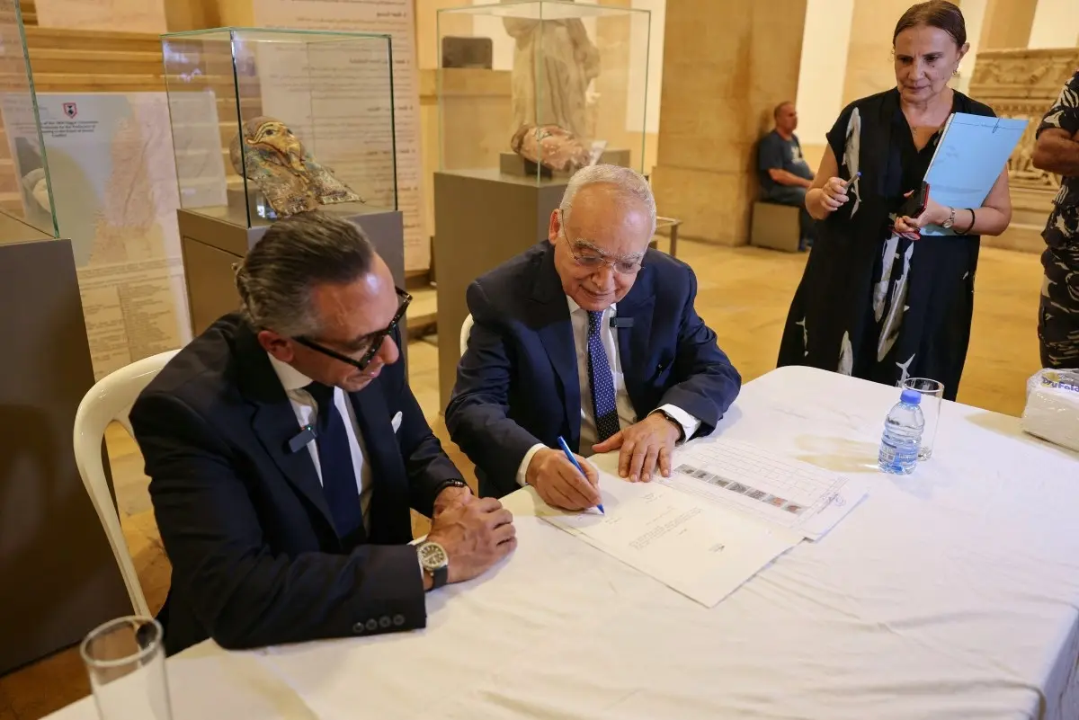 Lebanon's Minister of Culture Ghassan Salameh (C) and Egypt's Ambassador to Lebanon Alaa Moussa (L) sign the handover documents of illegally smuggled artifacts that date back to the Egyptian pharaonic era during a ceremony at the National Museum of Beirut on September 16, 2026. 