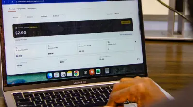 Hamid Bashir, product manager at Distinction Labs, showing a dashboard on Distinction AI indicating how creators earn revenue on the platform at FlexiSaf’s office