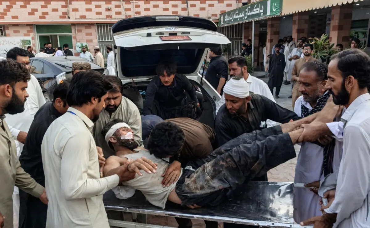 People carry an injured blast victim inside a hospital at Dera Ismail Khan in Pakistan's Khyber Pakhtunkhwa province on September 26, 2026.