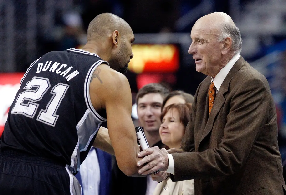 FILE - San Antonio Spurs power forward Tim Duncan (21) shakes hands with former NBA player Bob Pettit before the start of the Spurs New Orleans Hornets NBA basketball game in New Orleans, Monday, Jan. 7, 2013.