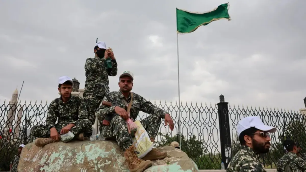 Members of Houthi security forces sit on a rock at the site of a rally held to commemorate Mawlid, marking the anniversary of Prophet Muhammad's birthday, in Sanaa, Yemen, August 25, 2026 [Khaled Abdullah/Reuters]
