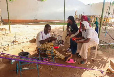 Solantine Maifrigi, and others preparing thread for weaving in Garoua