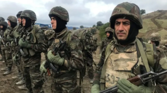 Algerian soldiers stand guard, in the Ain Defla mountains, west of the capital Algiers, Algeria,