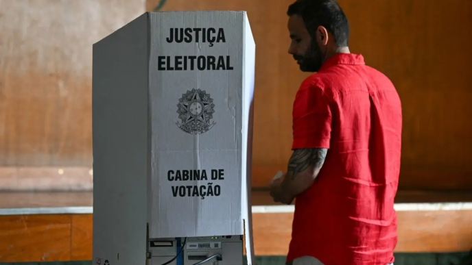 A voter stands beside a voting booth during the presidential election at a polling station in Rio de Janeiro, Brazil, on October 4, 2026.