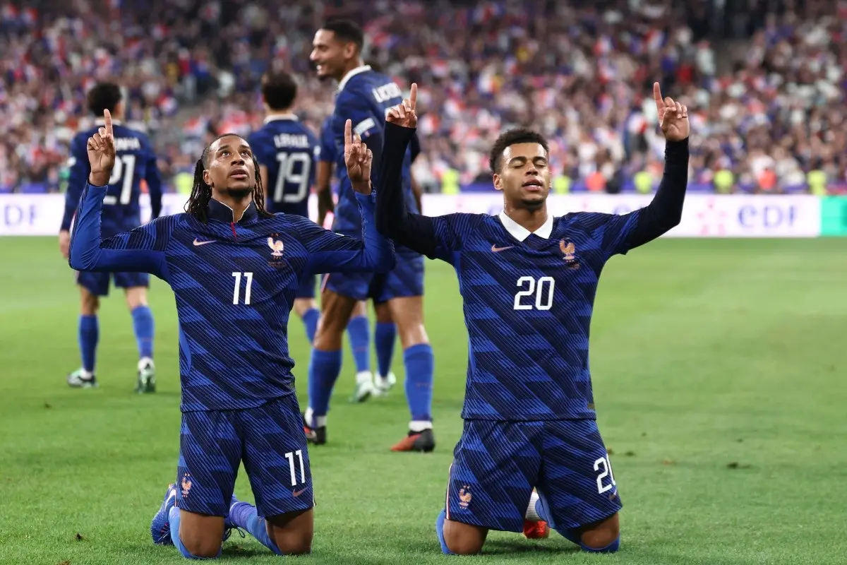 France's midfielder #11 Michael Olise (L) celebrates with France's forward #20 Desire Doue after scoring his team's fourth goal during the UEFA Nations League Group A1 football match between France and Belgium at the Stade de France in Saint-Denis, north of Paris, on October 5, 2026.