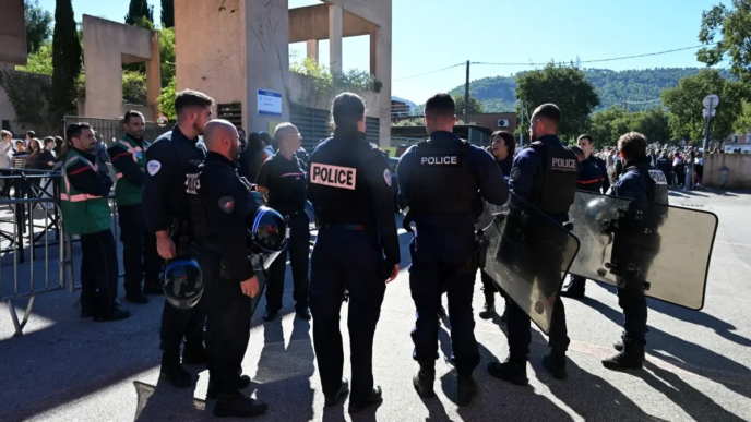 Policemen stand in front of Joseph-Lakanal middle school after a headmaster was injured by a hunting rifle shot and a teenager was arrested in Aubagne, southern France, on October 12, 2026.