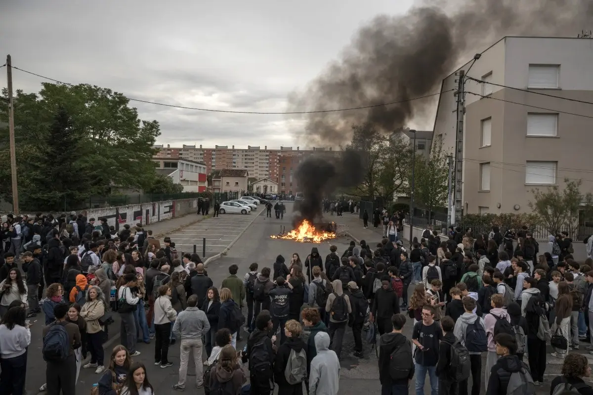 Protesters and high-school students take part in a demonstration outside the Lycee Toulouse Lautrec, in Toulouse on October 12, 2026.