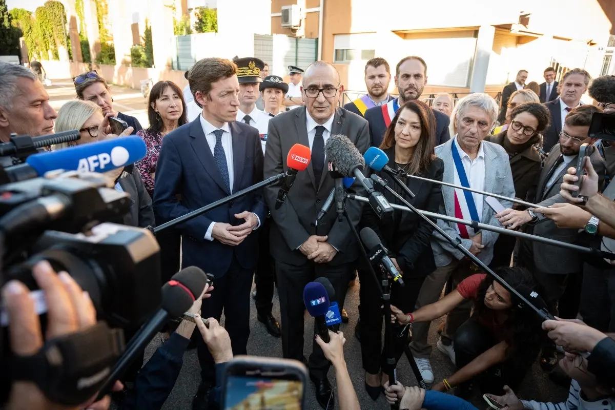 France's Interior Minister Laurent Nunez (C), flanked by France's Education Minister Edouard Geffray (L), junior Minister for Education Sabrina Roubache and Martigue's mayor Jean-Pierre Squillari, talks to the press as he leaves the Joseph-Lakanal Middle School where a 14-year-old boy opened fire with a hunting rifle, injuring the headmaster and a teacher before being disarmed by a member of staff, in the southern town of Aubagne, near Marseilleon October 12, 2026.
