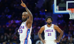 PHILADELPHIA, PENNSYLVANIA - OCTOBER 16: LeBron James #23 of the Philadelphia 76ers points as Joel Embiid #21 looks on against the Boston Celtics in the first quarter during the preseason game at Xfinity Mobile Arena on October 16, 2026 in Philadelphia, Pennsylvania.