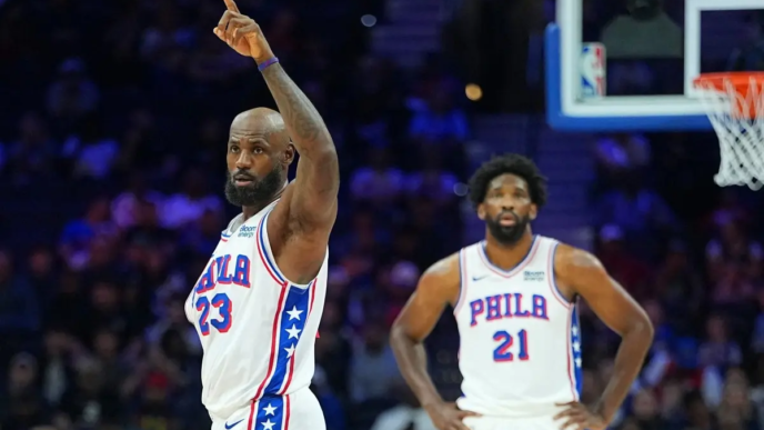 PHILADELPHIA, PENNSYLVANIA - OCTOBER 16: LeBron James #23 of the Philadelphia 76ers points as Joel Embiid #21 looks on against the Boston Celtics in the first quarter during the preseason game at Xfinity Mobile Arena on October 16, 2026 in Philadelphia, Pennsylvania.