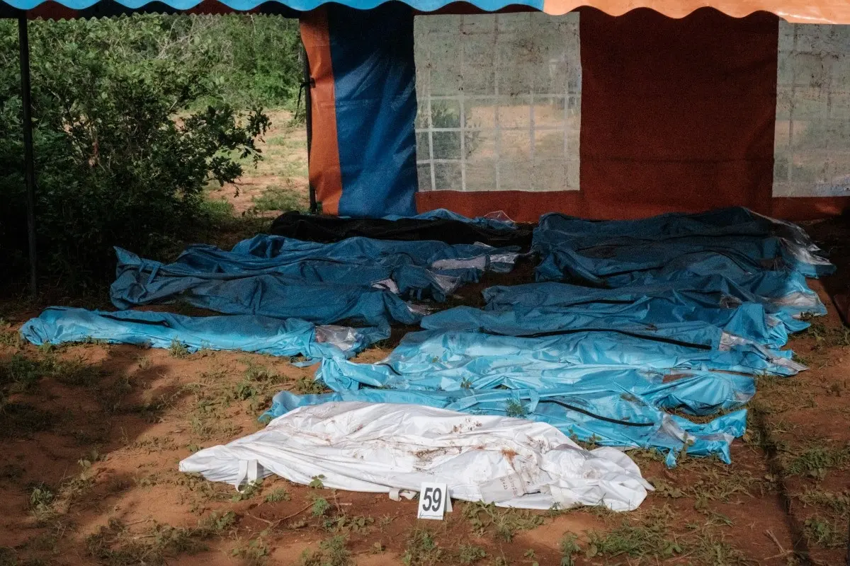 Exhumed bodies in bodybags are displayed on the ground prior to a transport to the mortuary, at the mass-grave site in Shakahola, outside the coastal town of Malindi, on April 25, 2023.