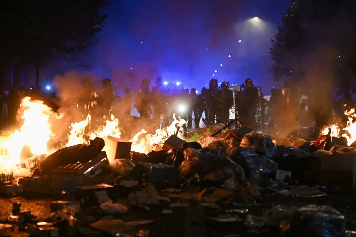 This photograph shows a television monitor broadcasting France's President Emmanuel Macron giving a speech from the Elysee Presidential Palace the day after riots and looting on the sidelines of nationwide protests against the "high cost of living", in Paris on October 18, 2026.