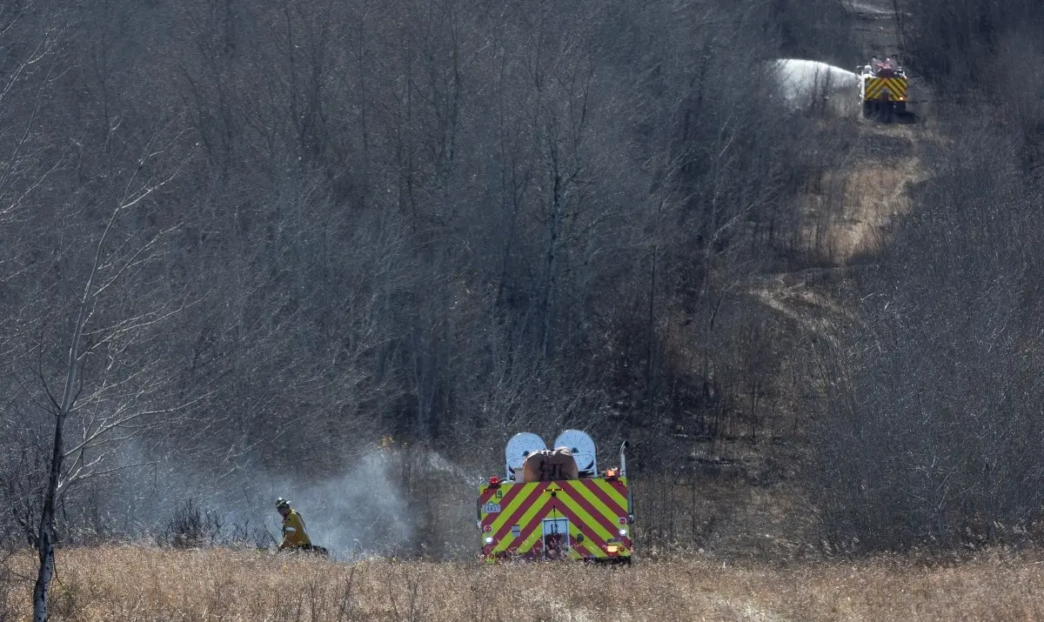 Firefighters continue to work close to Canadian Forces Base Wainwright in Wainwright, Alberta, Canada, on October 18, 2026.