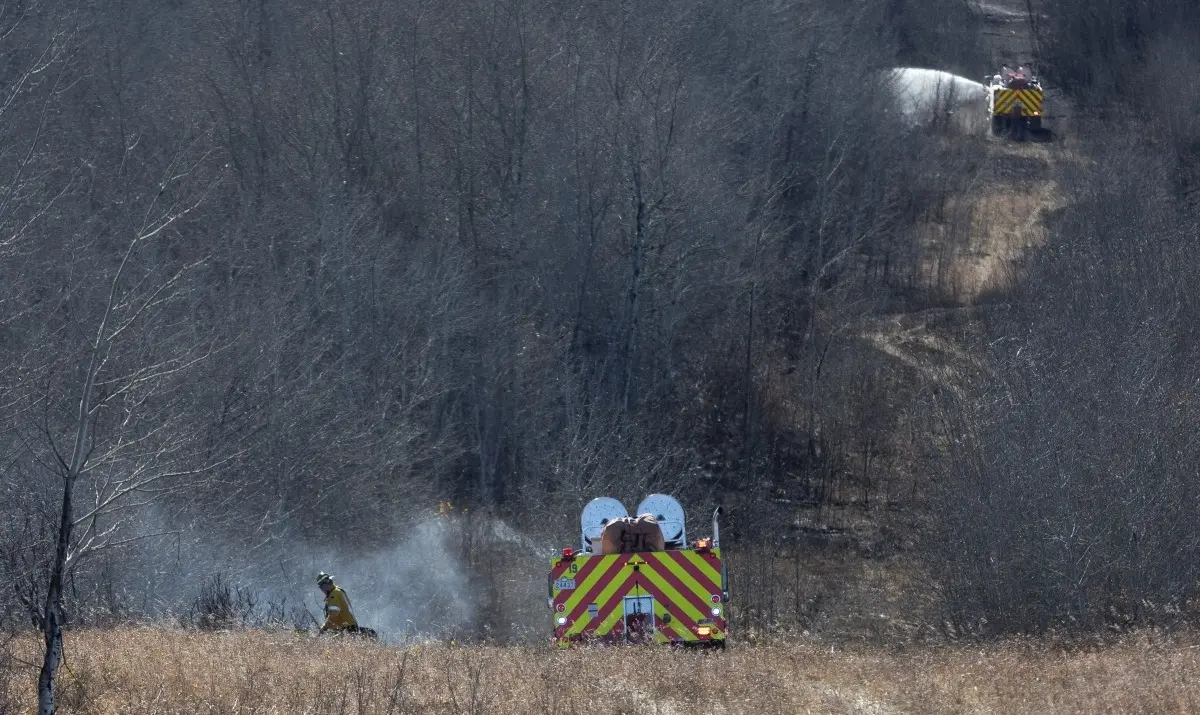 Firefighters continue to work close to Canadian Forces Base Wainwright in Wainwright, Alberta, Canada, on October 18, 2026.