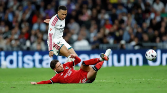 Real Madrid's French forward #10 Kylian Mbappe fights for the ball with Sevilla's Spanish defender #22 Jose Angel Carmona (down) during the Spanish league football match between Real Madrid CF and Sevilla FC at the Santiago Bernabeu stadium in Madrid on October 18, 2026.