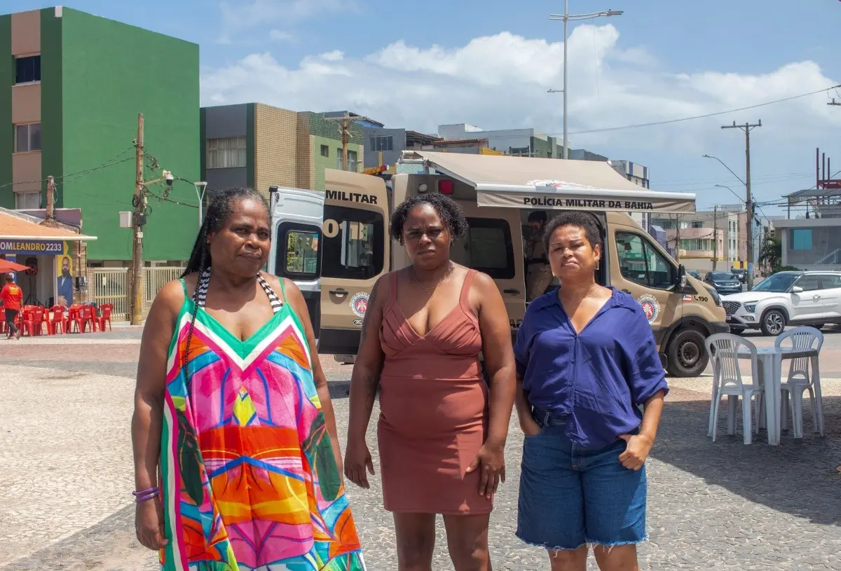 Rita Cassia, Elisangela Souza Santos and Vilma Alves de Oliveira, who allege that family members were killed during police operations, pose for a photograph along the waterfront opposite the Nordeste de Amaralina complex in Salvador, Bahia state, Brazil, on September 12, 2026.