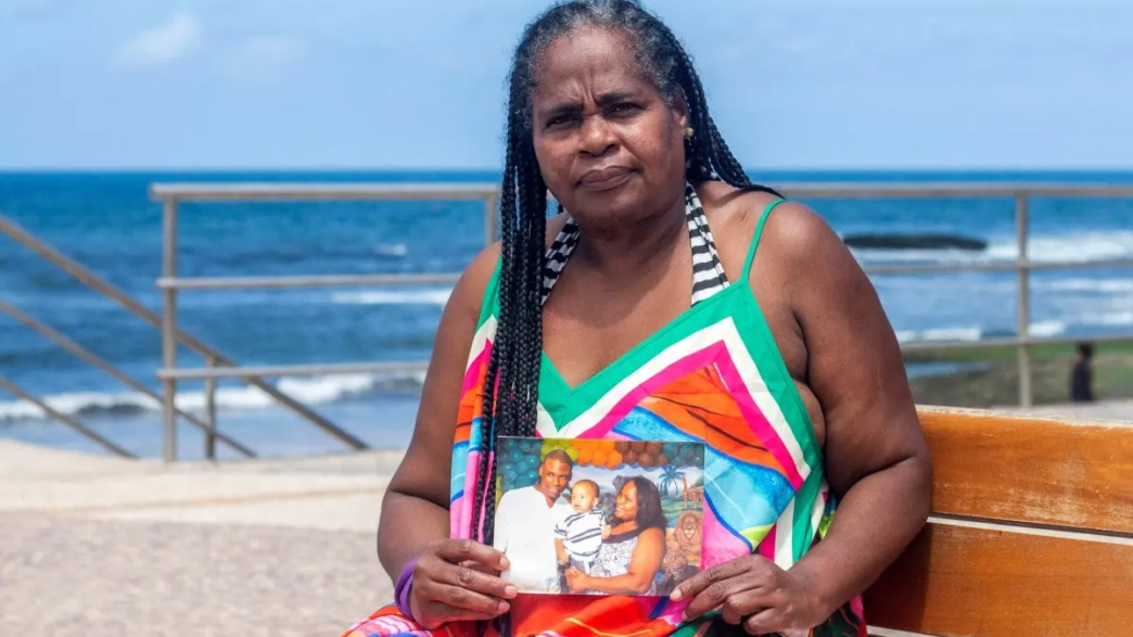 Rita Cassia, the mother of Carlos Alberto, who she alleges was killed by Bahia's Military Police during a police operation in the Nordeste de Amaralina complex in 2013, poses for a portrait with photographs of her son in Salvador, Bahia state, Brazil, on September 12, 2026