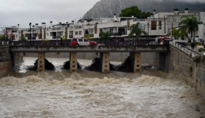 A fire service vehicle is seen on a bridge over the swollen Girona River following torrential downpours in Els Poblets, eastern Spain, on October 19, 2026.