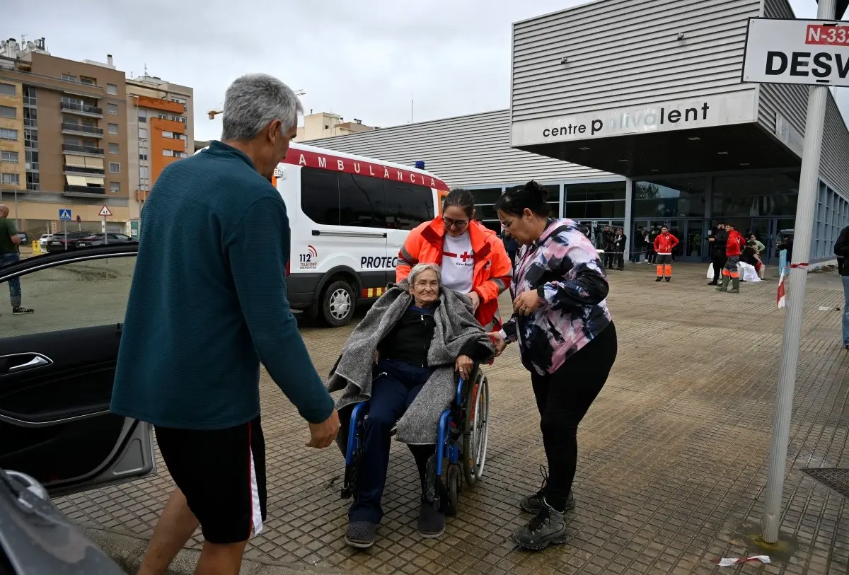 A resident in a wheelchair rescued from her home by helicopter is taken to a medical facility following torrential downpours in Oliva, eastern Spain, on October 19, 2026.