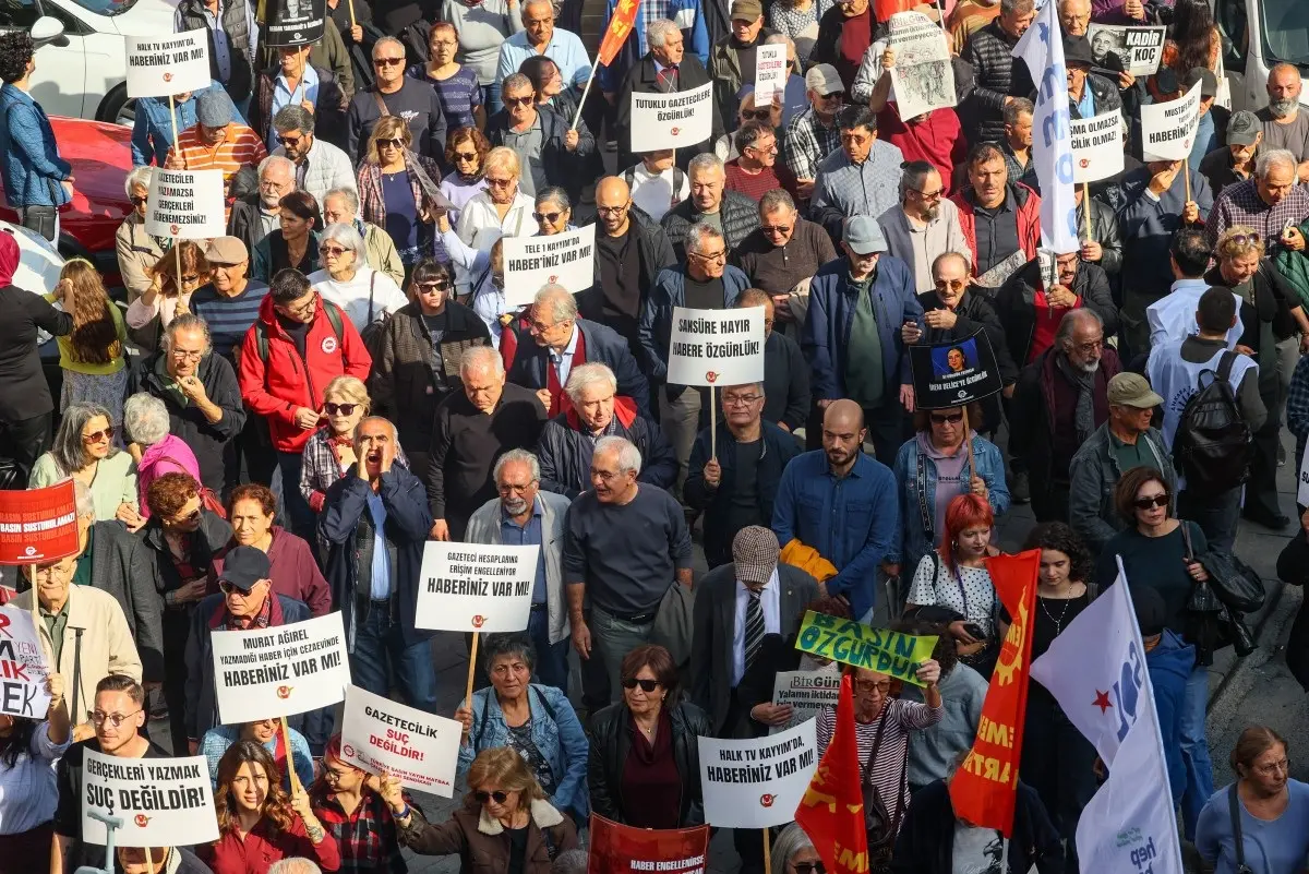 Demonstrators hold placards reading "Journalism is not a crime. Free media can't be silenced" during a rally against what they described as growing pressure on journalists including arrests and media shutdowns, in Ankara, on October 24, 2026.