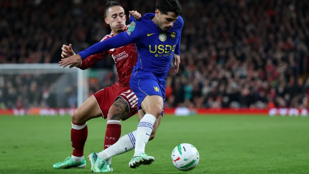 Liverpool's Greek defender #21 Kostas Tsimikas pulls the shirt of Chelsea's Portuguese midfielder #07 Pedro Neto during the English League Cup fourth round football match between Liverpool and Chelsea at Anfield in Liverpool, north west England on October 28, 2026