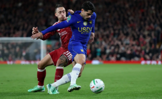 Liverpool's Greek defender #21 Kostas Tsimikas pulls the shirt of Chelsea's Portuguese midfielder #07 Pedro Neto during the English League Cup fourth round football match between Liverpool and Chelsea at Anfield in Liverpool, north west England on October 28, 2026