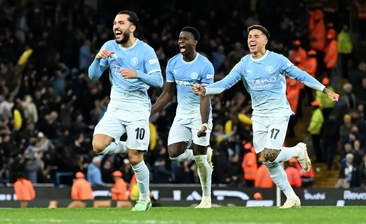 Manchester City's French midfielder #10 Rayan Cherki, Manchester City's English defender #06 Marc Guehi and Manchester City's Argentinian midfielder #17 Enzo Fernandez celebrate winning the penalty shootout during the English League Cup fourth round football match between Manchester City and Brighton and Hove Albion at the Etihad stadium in Manchester, north-west England on October 28, 2026.