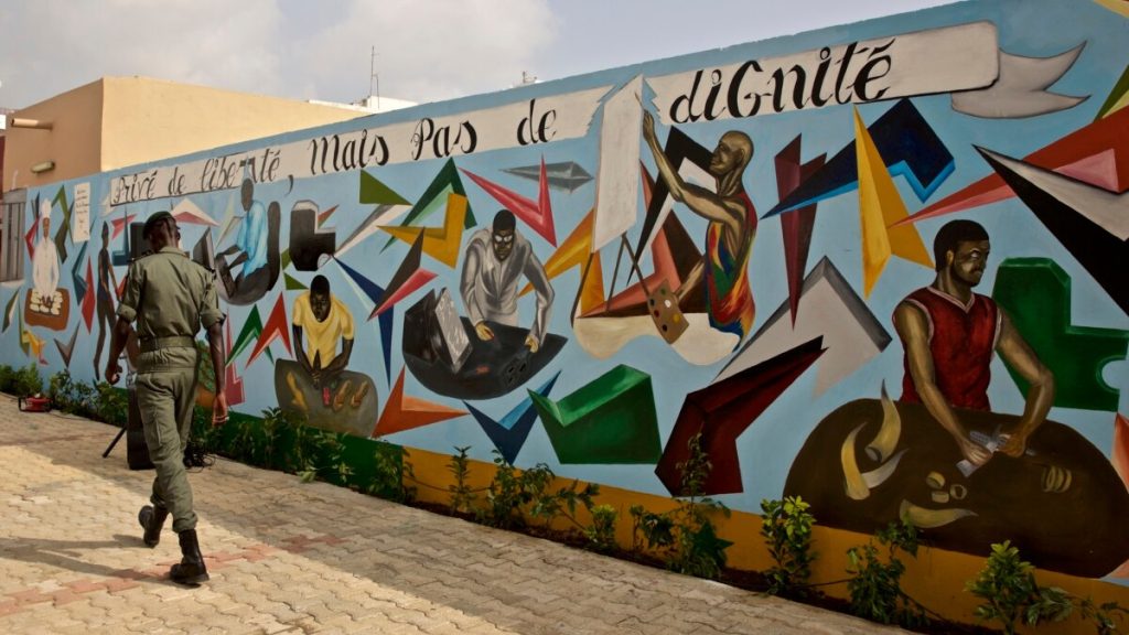 A prison warder walks through an overcrowded prison cell. Photo Credit: Mashable
